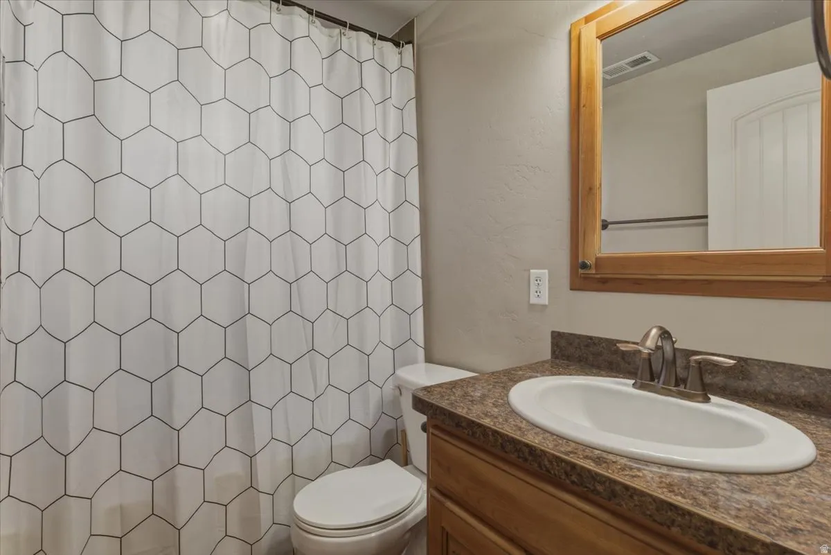 Bathroom featuring vanity and curtained shower