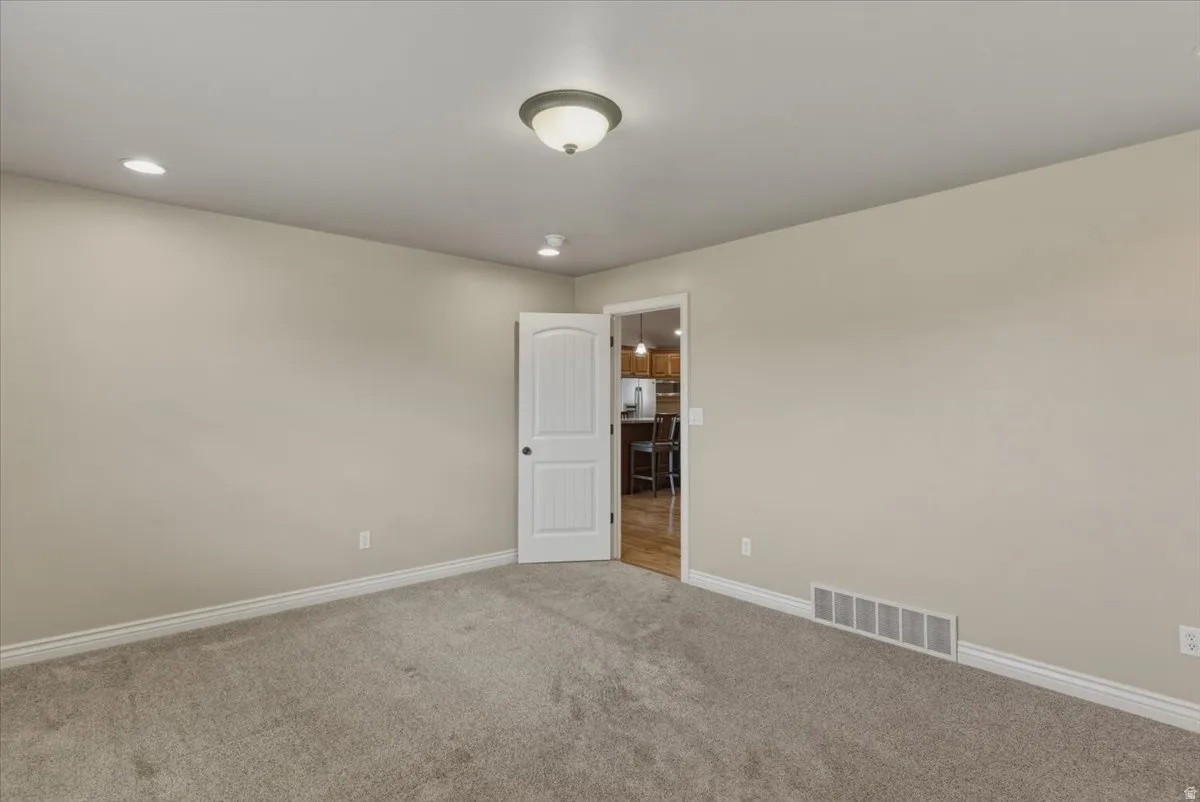 Unfurnished room featuring carpet and recessed lighting