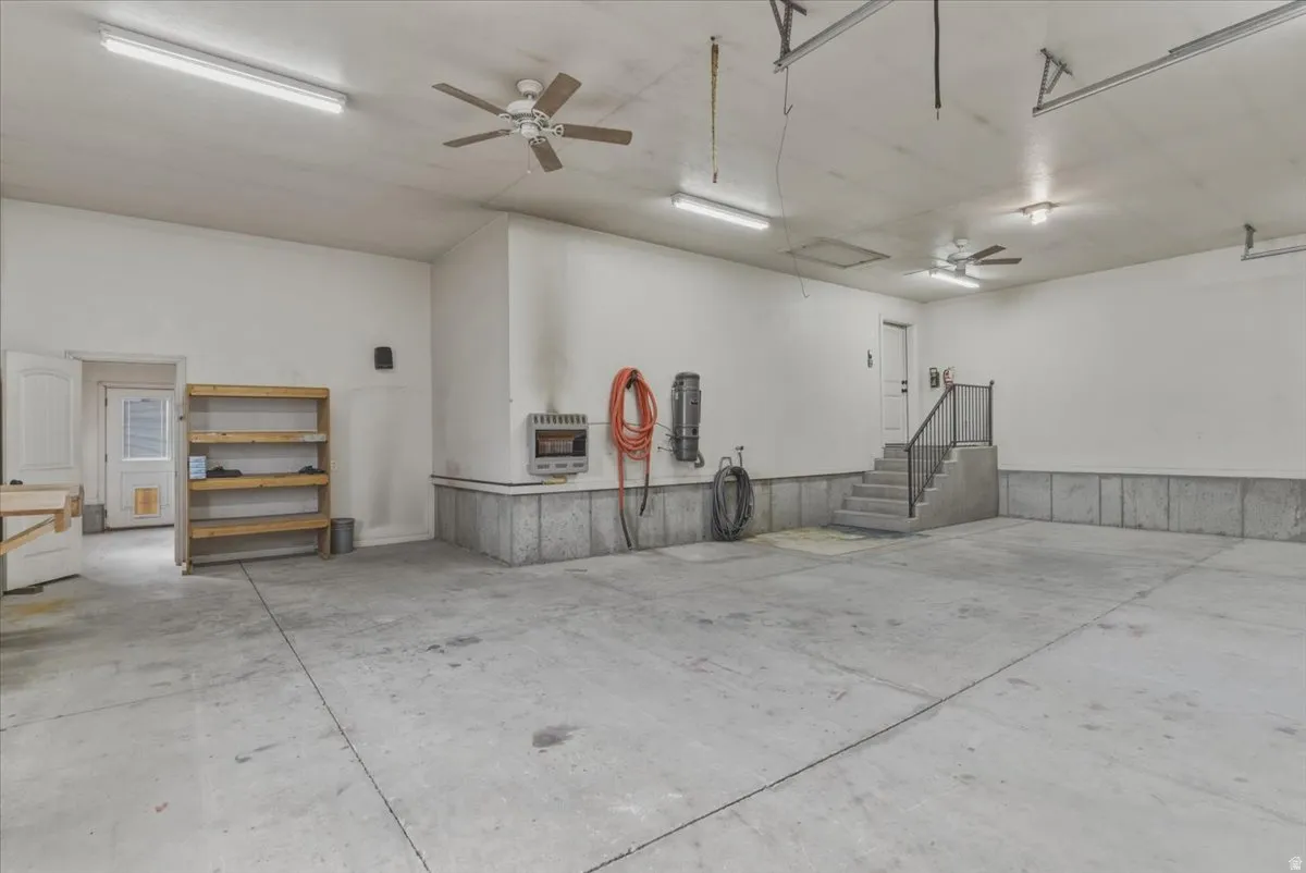 Garage featuring ceiling fan and heating unit