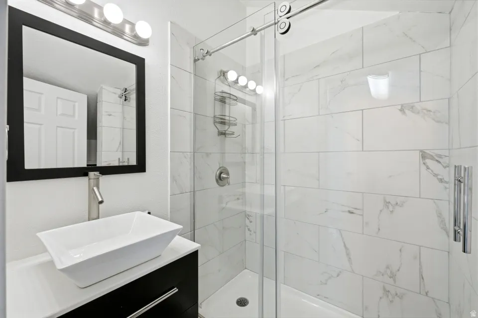 Bathroom with a stall shower and vanity