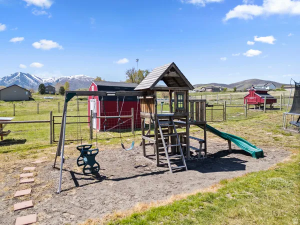 View of play area with a mountain view and a trampoline