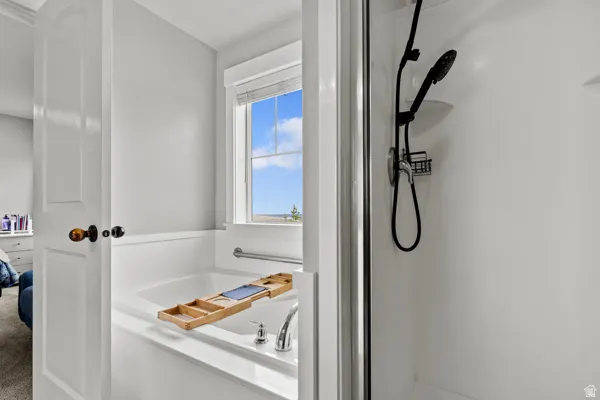 Ensuite bathroom with a stall shower and a bath