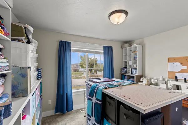 Bedroom with light carpet and baseboards