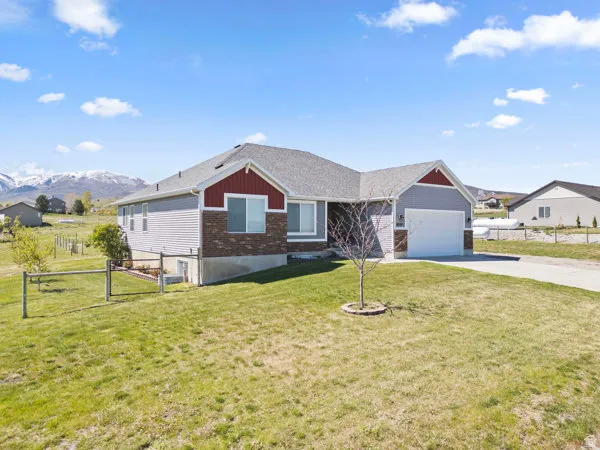 Single story home featuring driveway, a garage, a gate, brick siding, and a mountain view