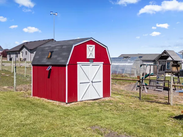 View of greenhouse with a storage shed