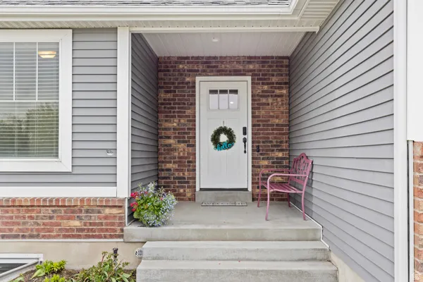 View of exterior entry featuring brick siding