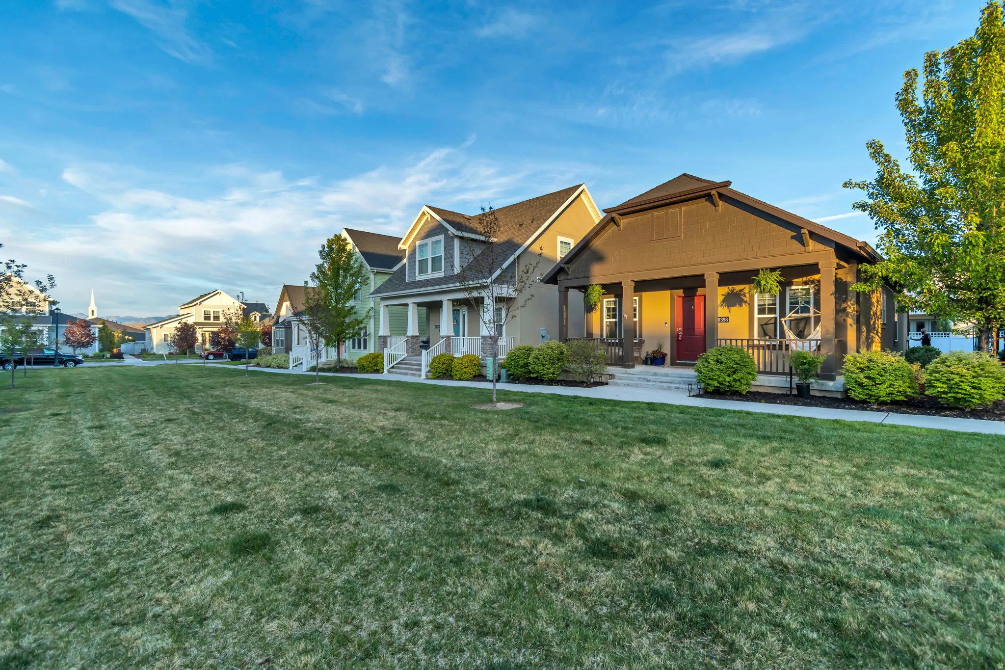 Craftsman house featuring covered porch, a front lawn, and a residential view