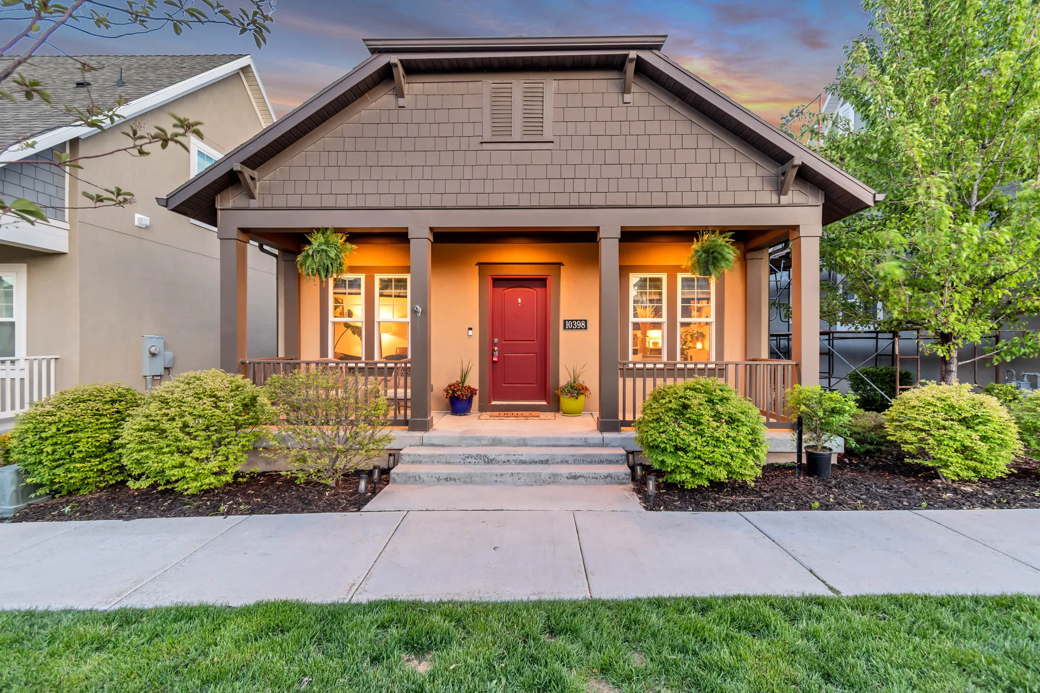 Craftsman inspired home featuring a porch and stucco siding