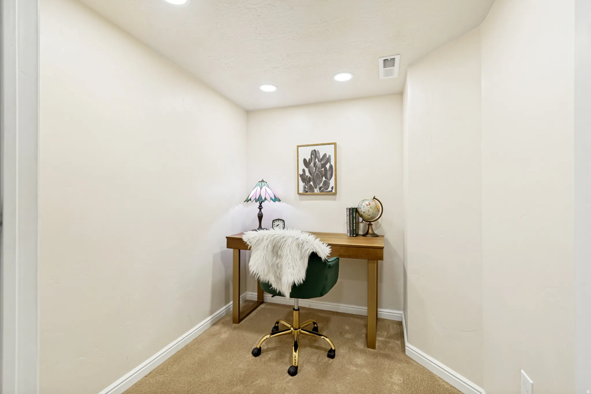 Office space with carpet floors and recessed lighting