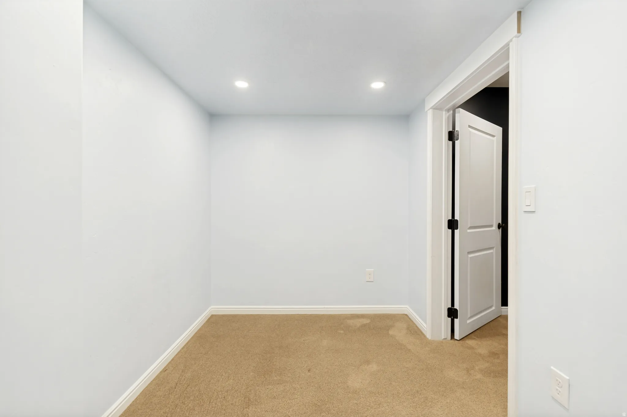 Spare room featuring light carpet and recessed lighting