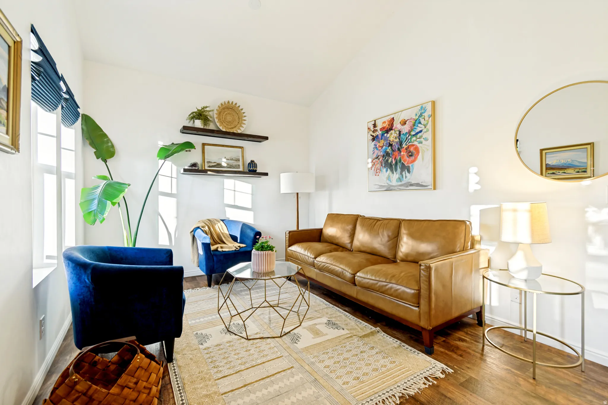 Living room with wood finished floors and vaulted ceiling