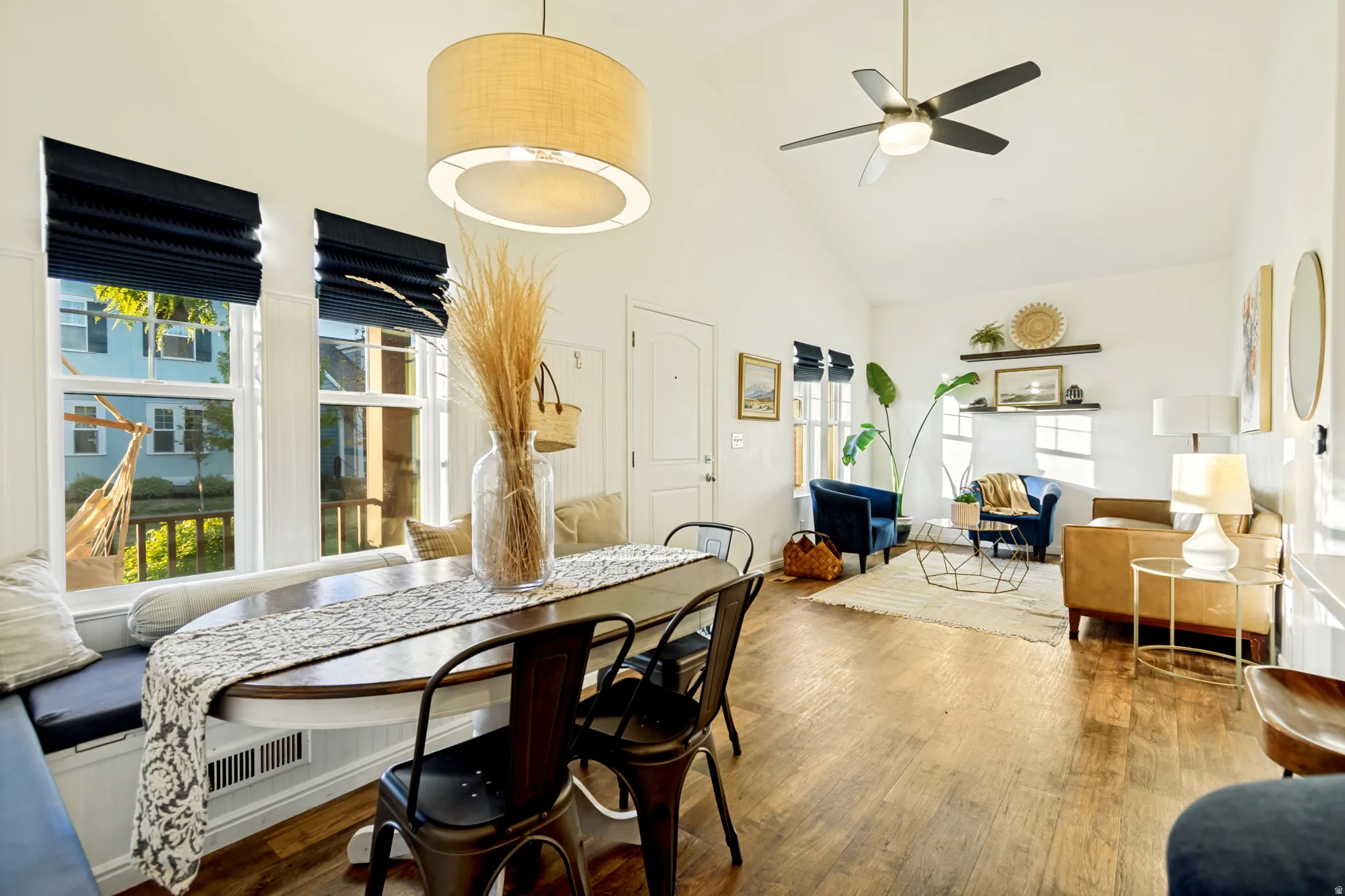 Dining space featuring vaulted ceiling, wood finished floors, and ceiling fan