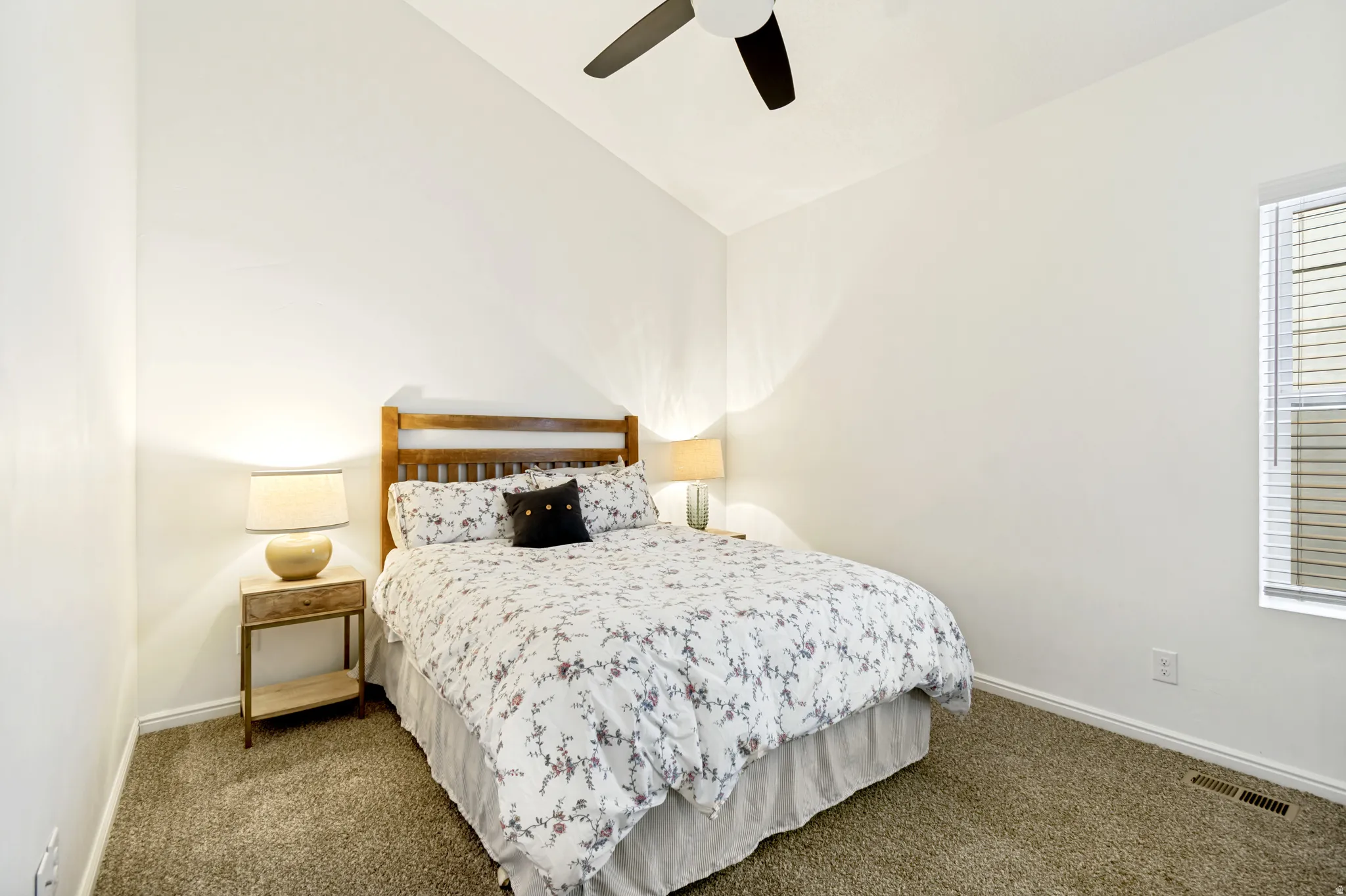 Bedroom featuring lofted ceiling, a ceiling fan, and dark colored carpet