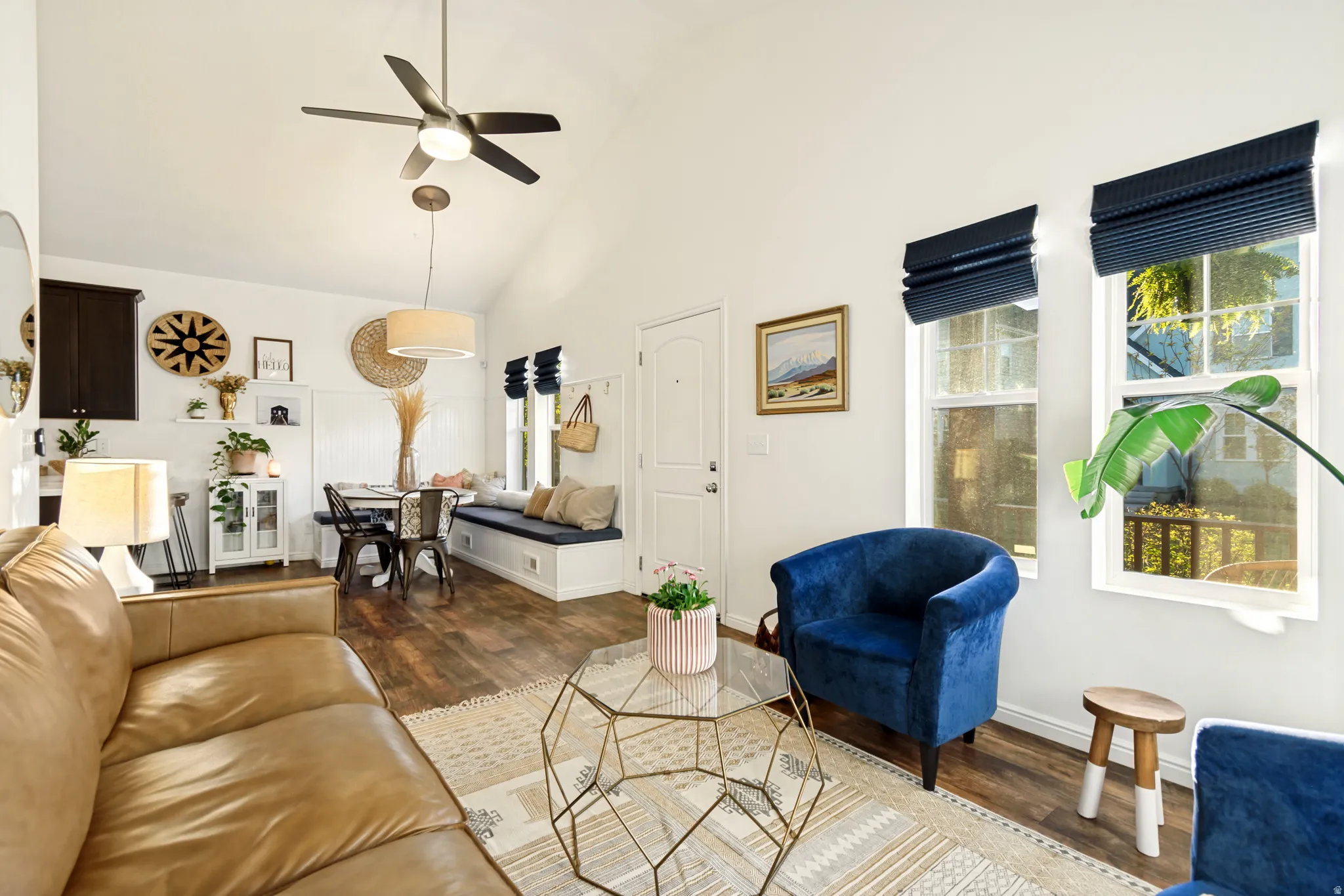 Living area featuring wood finished floors, ceiling fan, and lofted ceiling