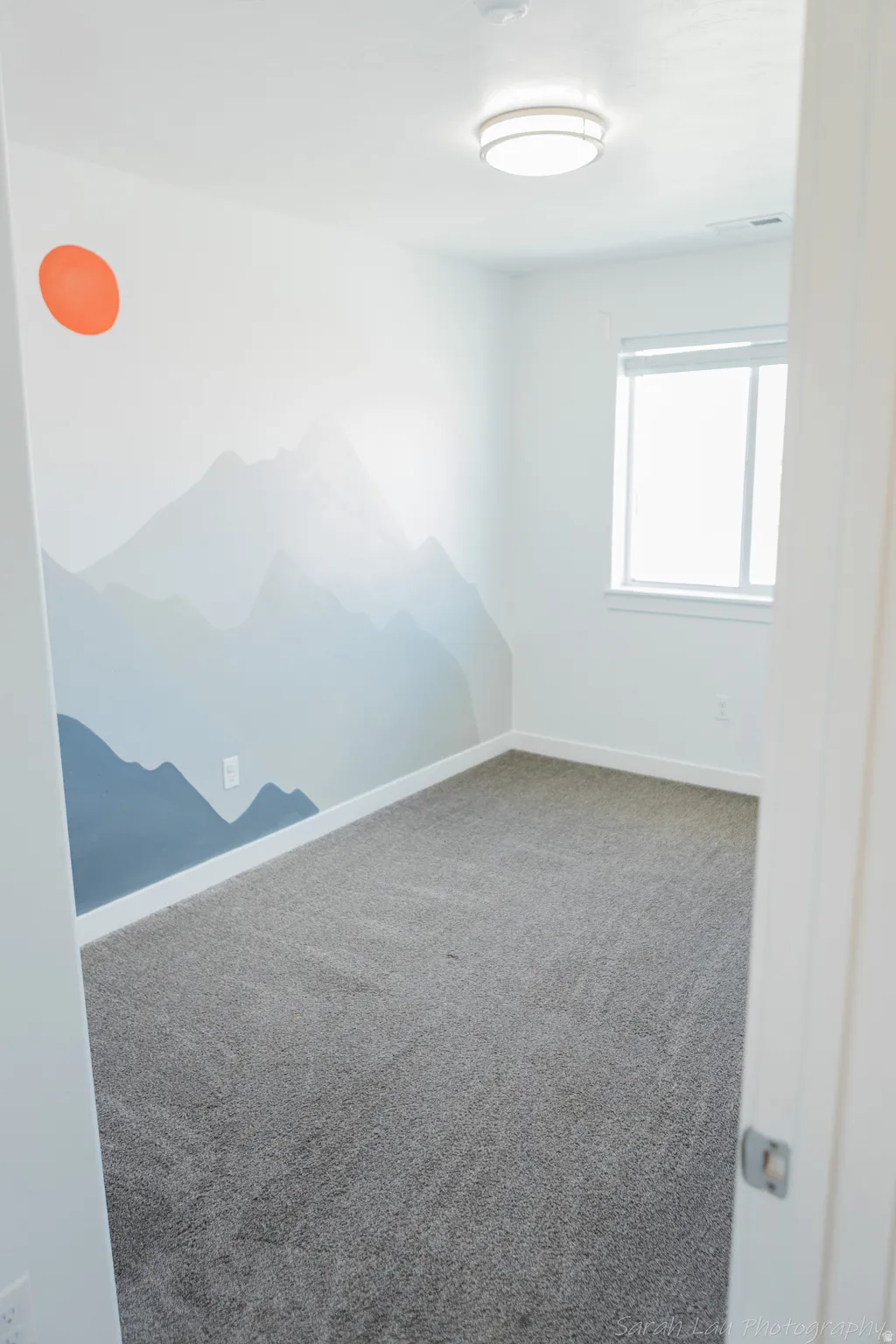 Carpeted empty room with baseboards