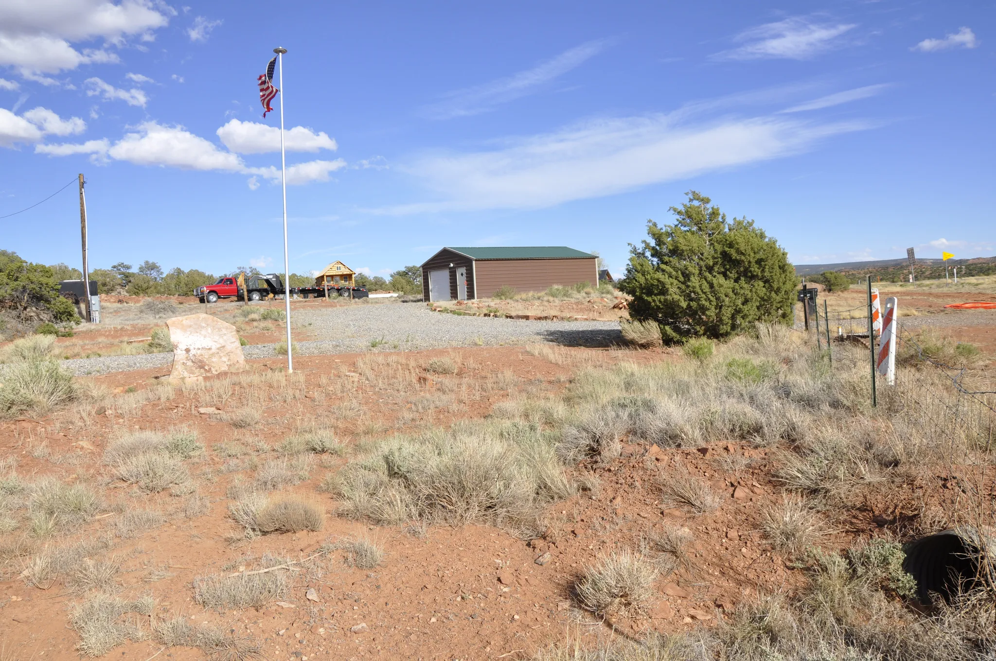 View of yard with an outdoor structure and a detached garage