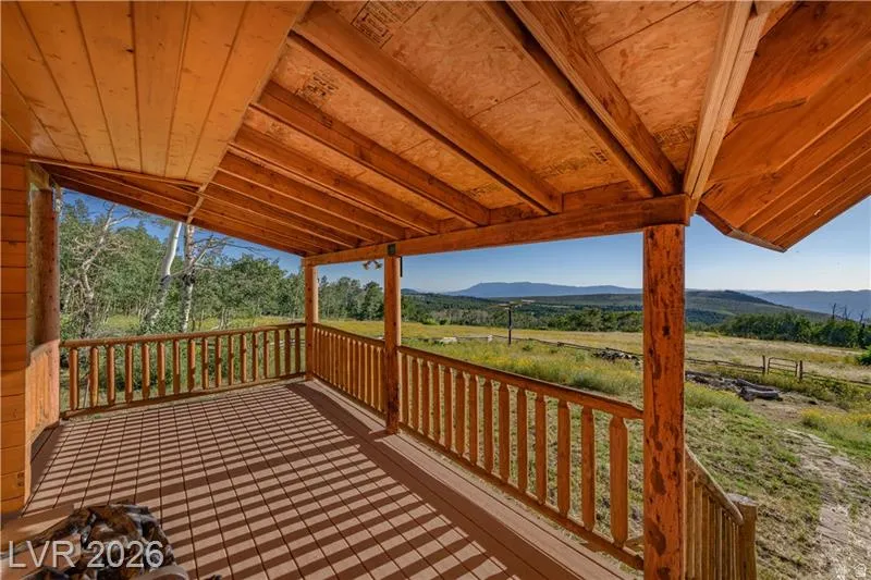 Wooden terrace featuring a mountain view and a view of countryside