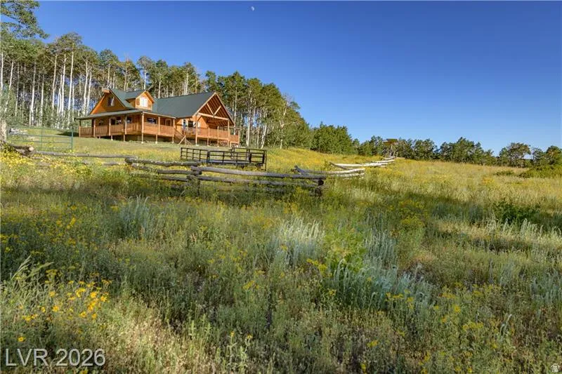 Rear view of property with a porch and a rural view