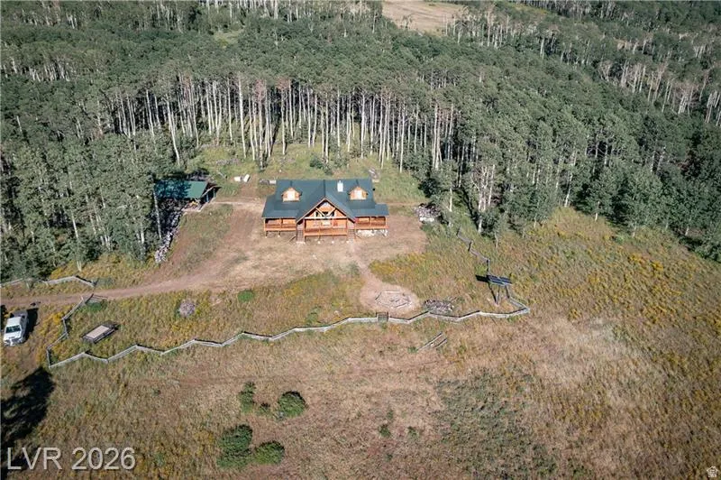 View of subject property featuring a forest