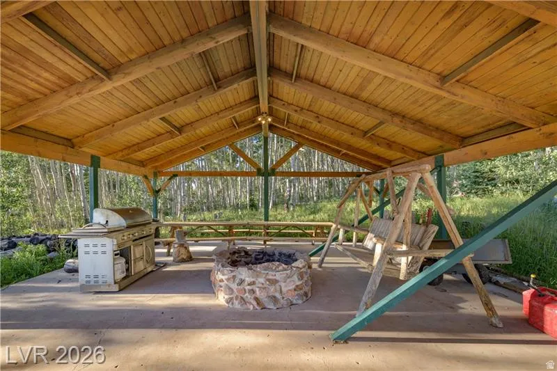 View of patio / terrace with an outdoor fire pit and a grill