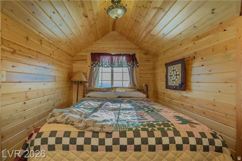 Bedroom featuring wood walls and wood ceiling
