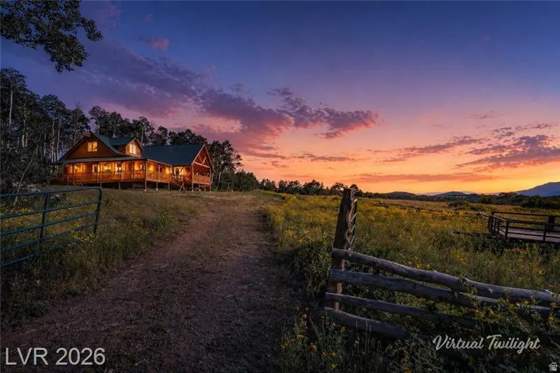 Yard at dusk with a porch and a view of countryside