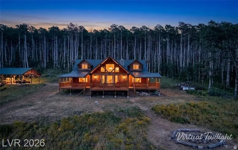 View of front of property with a large porch and a forest view