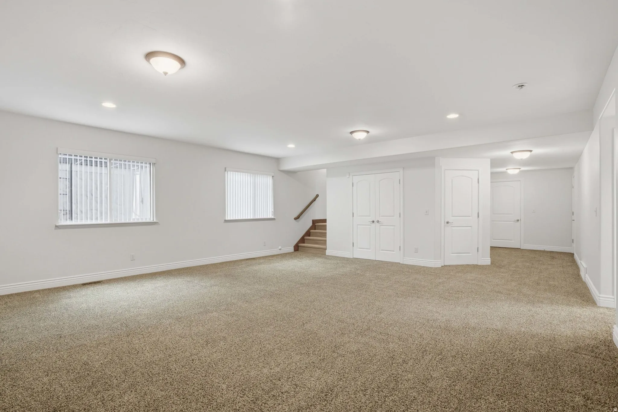 Below grade area with carpet flooring and recessed lighting