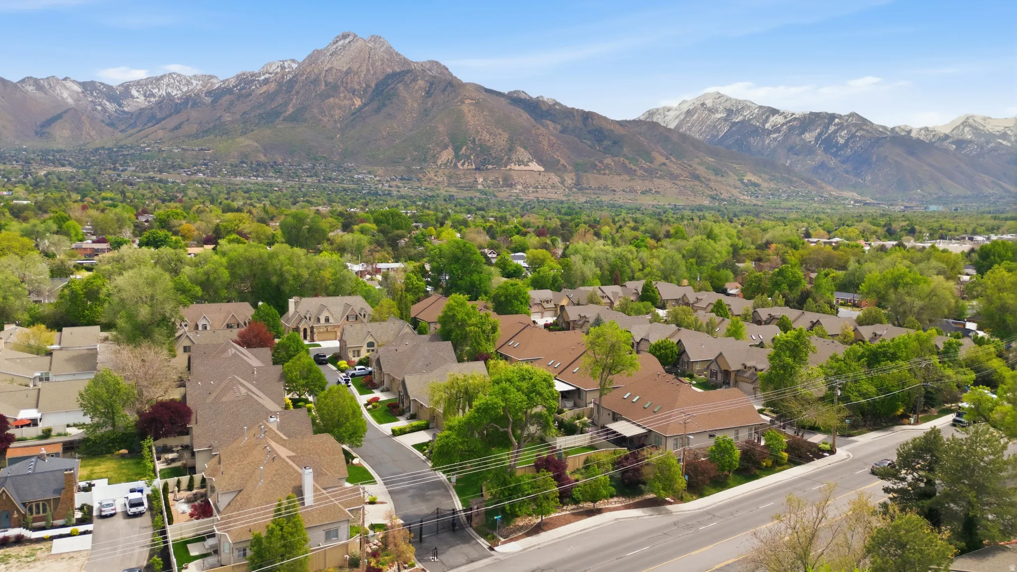 Aerial perspective of suburban area with a mountainous background