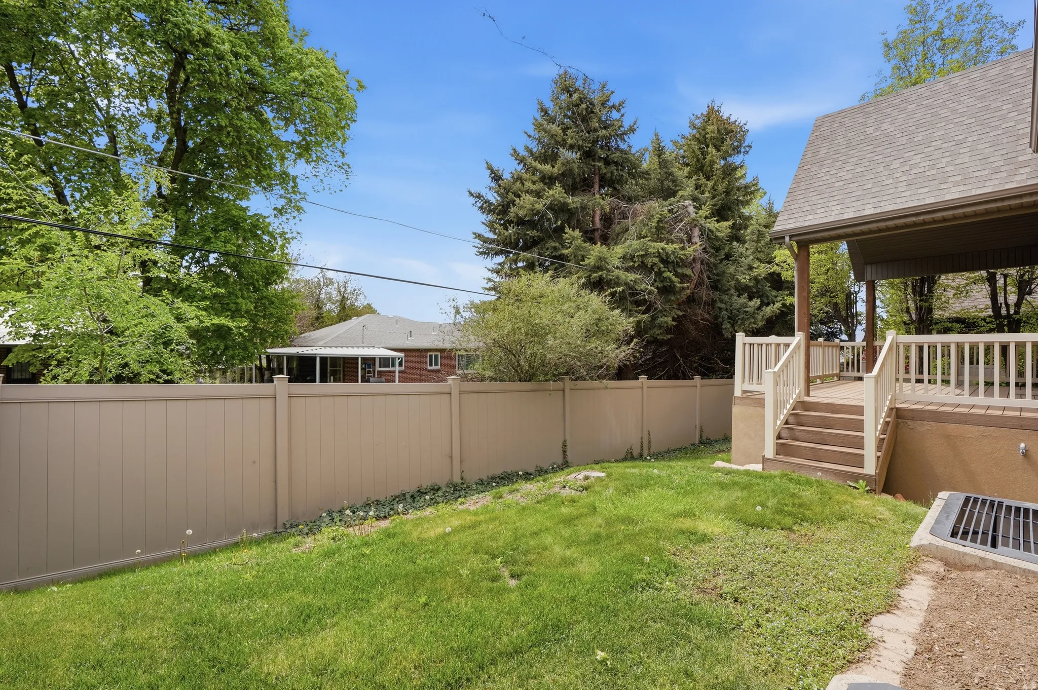 Fenced backyard with stairway and a wooden deck
