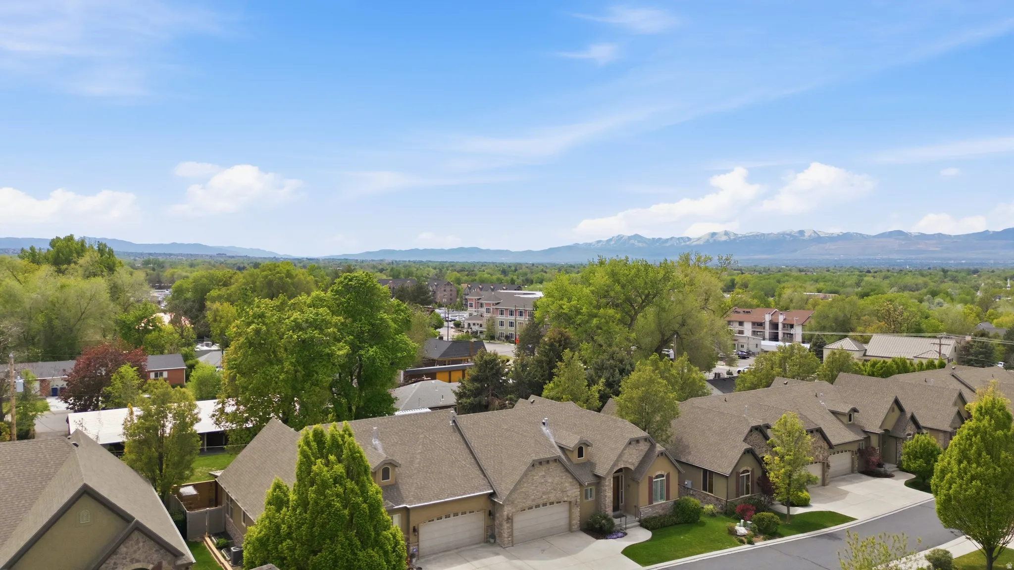 Aerial perspective of suburban area with a mountainous background