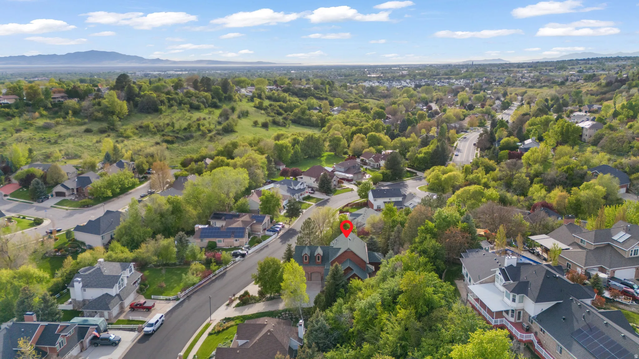 Aerial perspective of suburban area featuring a mountain backdrop