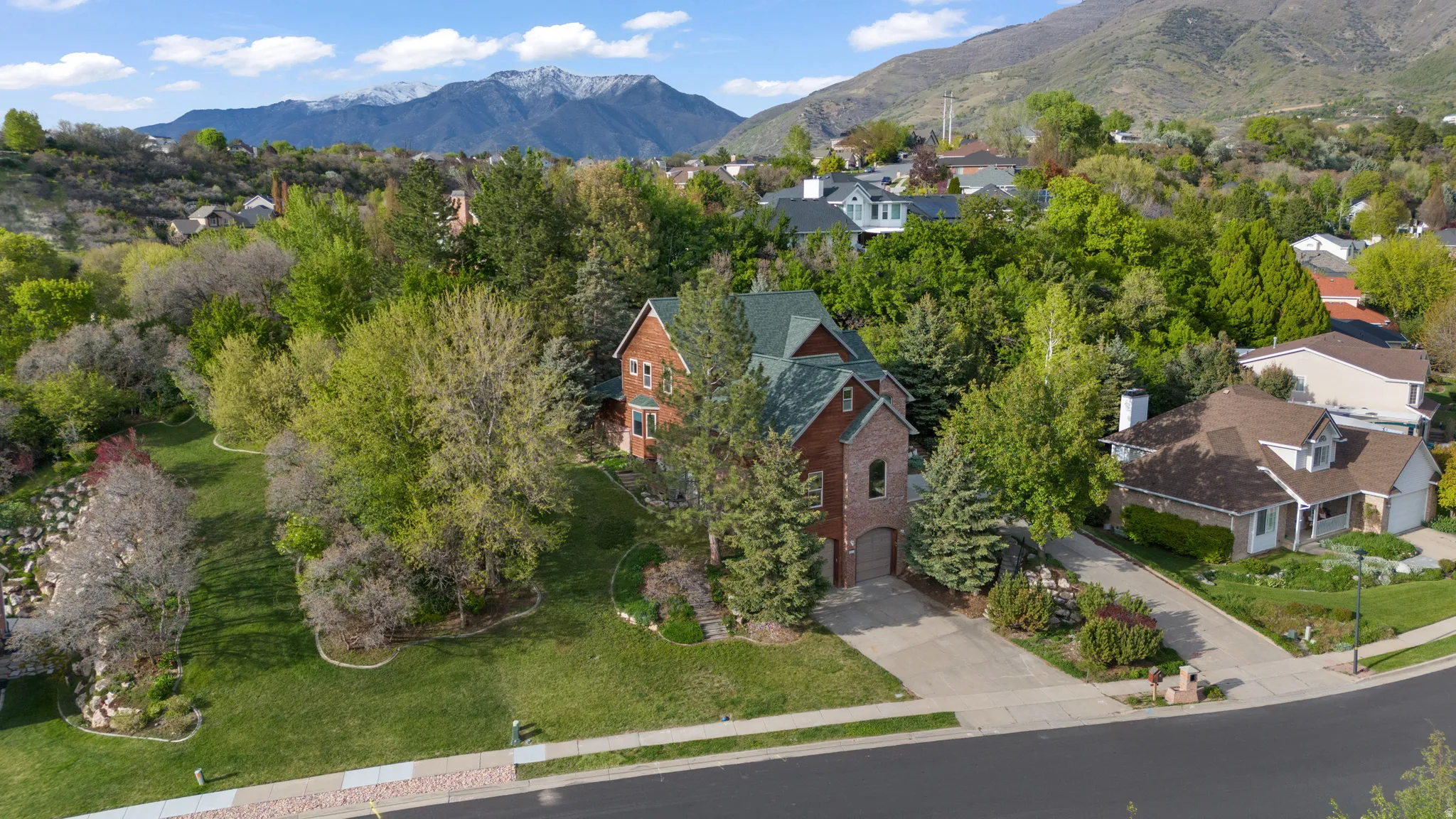 Aerial perspective of suburban area featuring a mountain backdrop