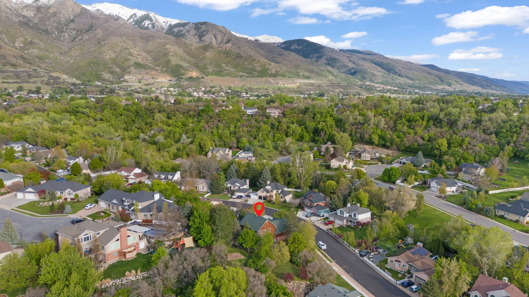 Aerial perspective of suburban area featuring a mountainous background