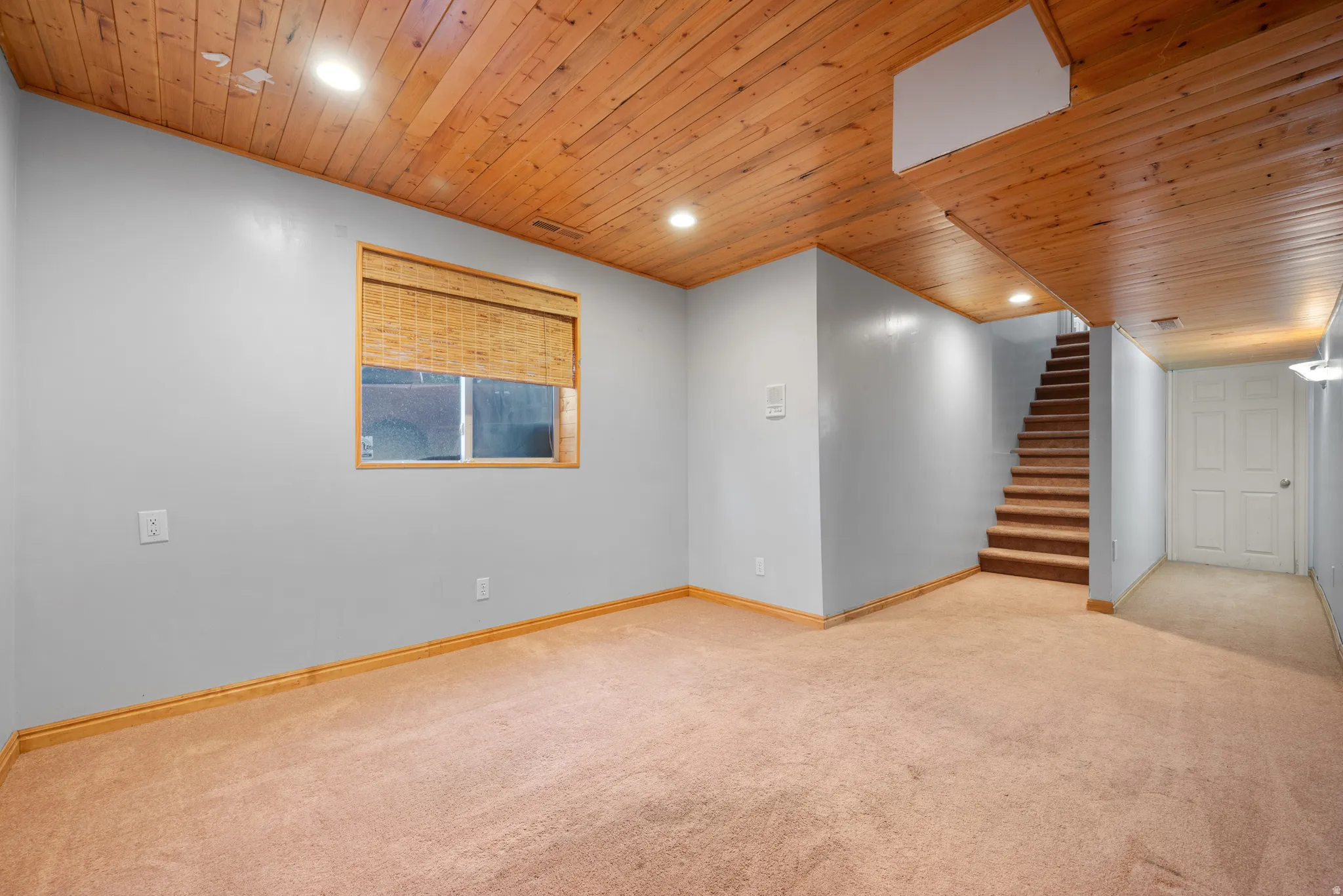 Unfurnished room featuring wood ceiling, light colored carpet, and recessed lighting