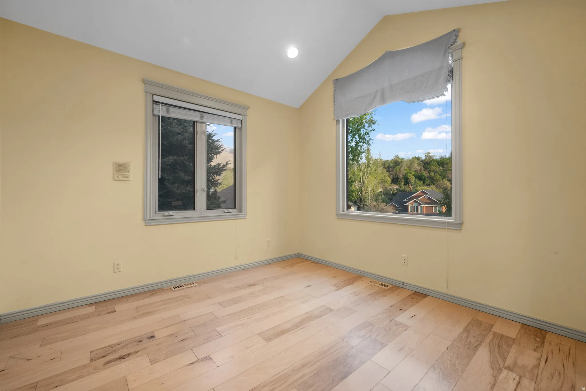 Office off entry  featuring vaulted ceiling, light wood-style flooring, and recessed lighting
