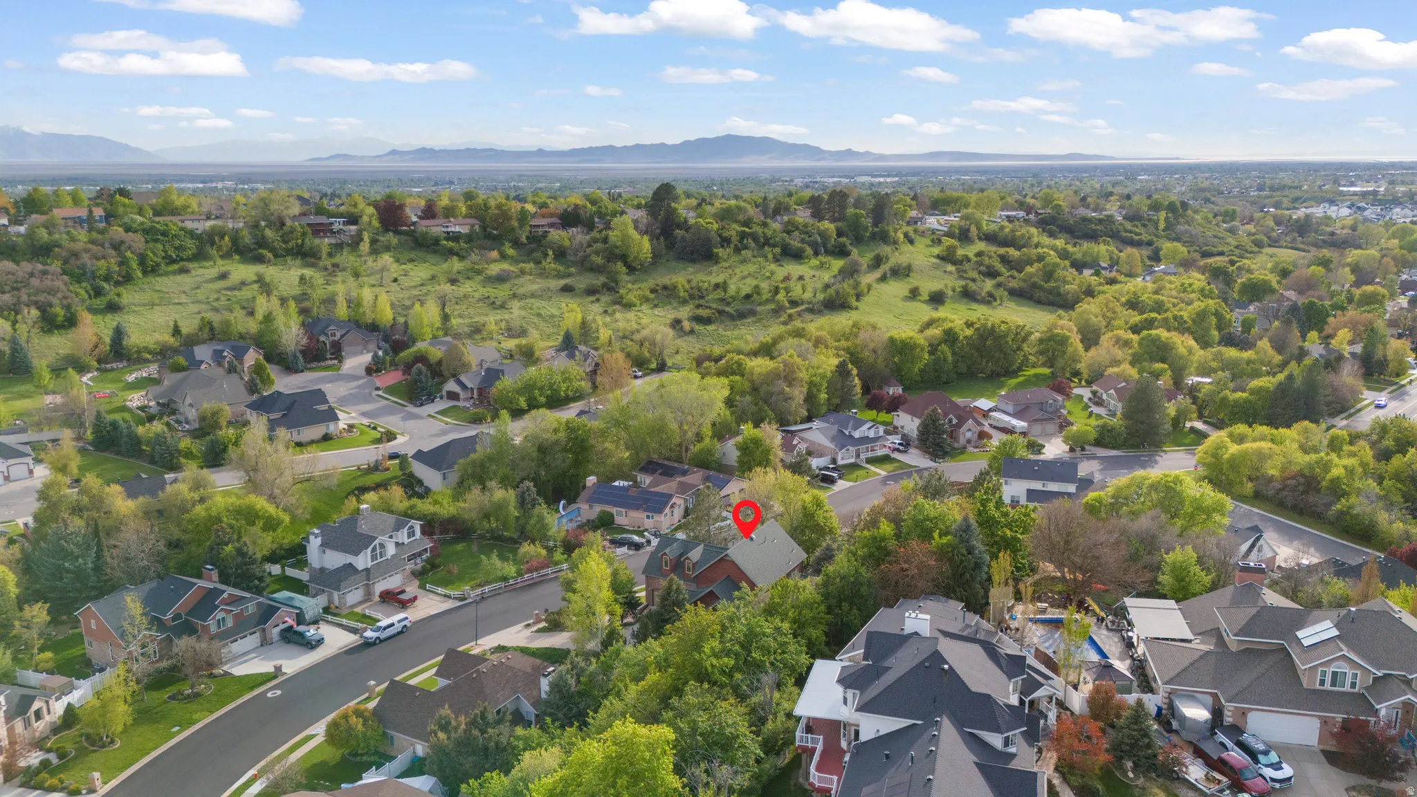 Aerial perspective of suburban area featuring a mountainous background
