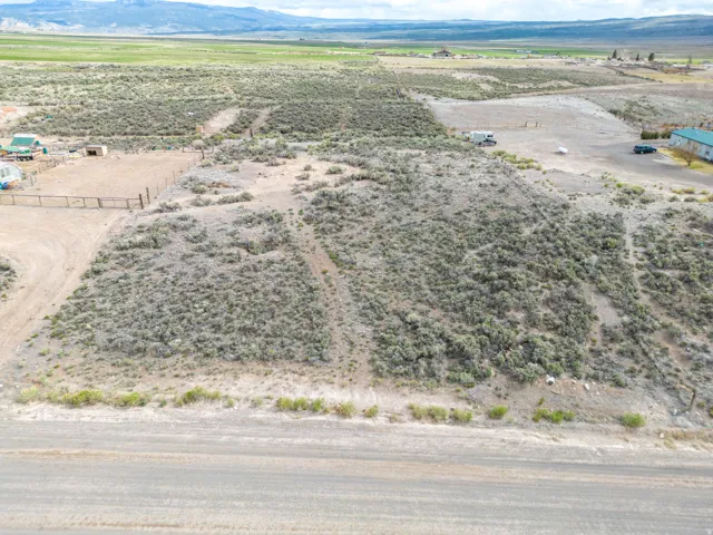 Aerial view of sparsely populated area featuring a mountain backdrop and a desert landscape