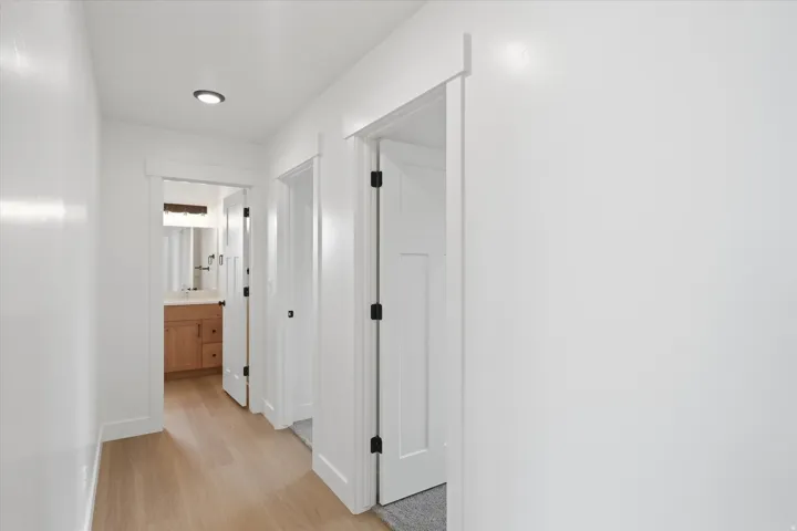 Corridor featuring light wood-type flooring and baseboards