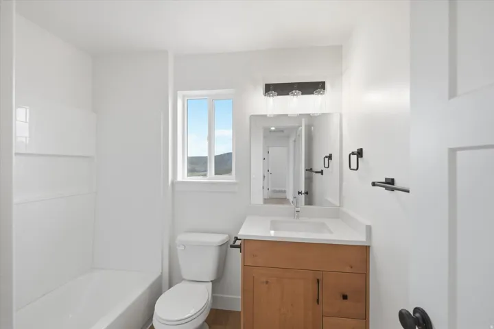 Bathroom with vanity and bathing tub / shower combination