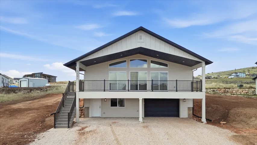 View of front of house featuring driveway, an attached garage, and board and batten siding