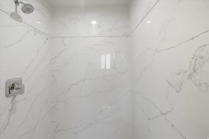 Bathroom view of a marble finish shower