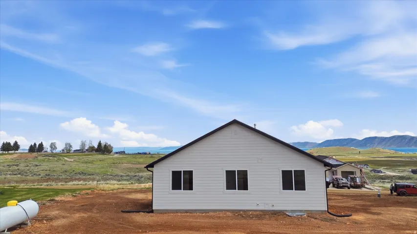 View of side of home with a mountain view