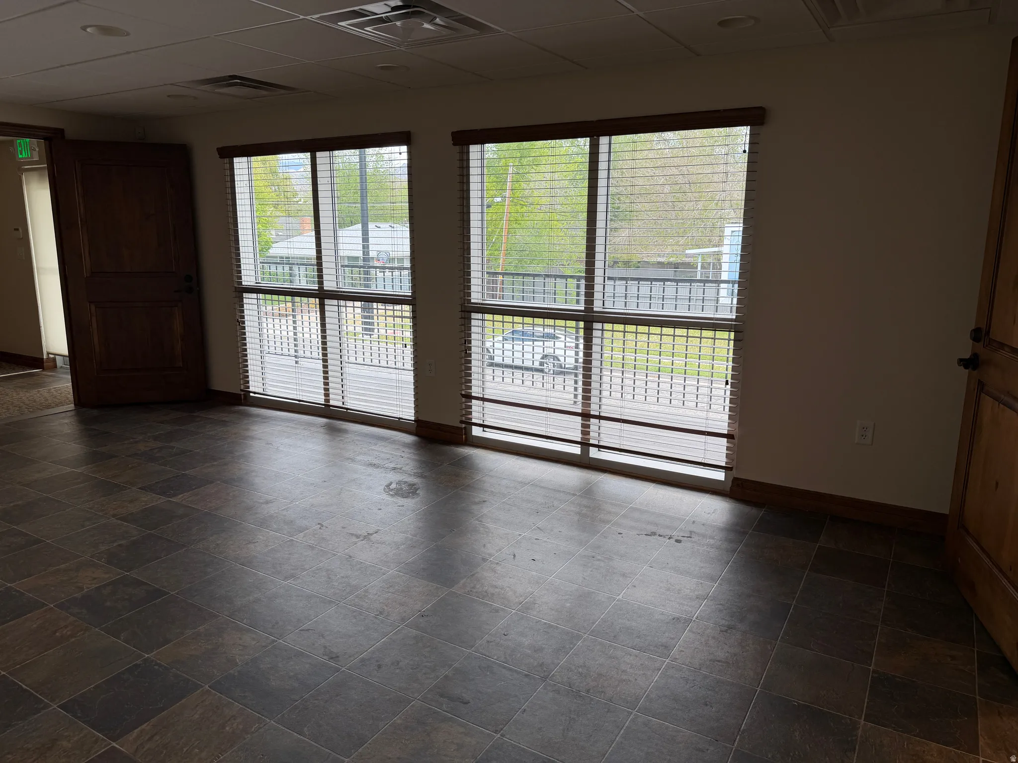 Spare room featuring a drop ceiling and baseboards