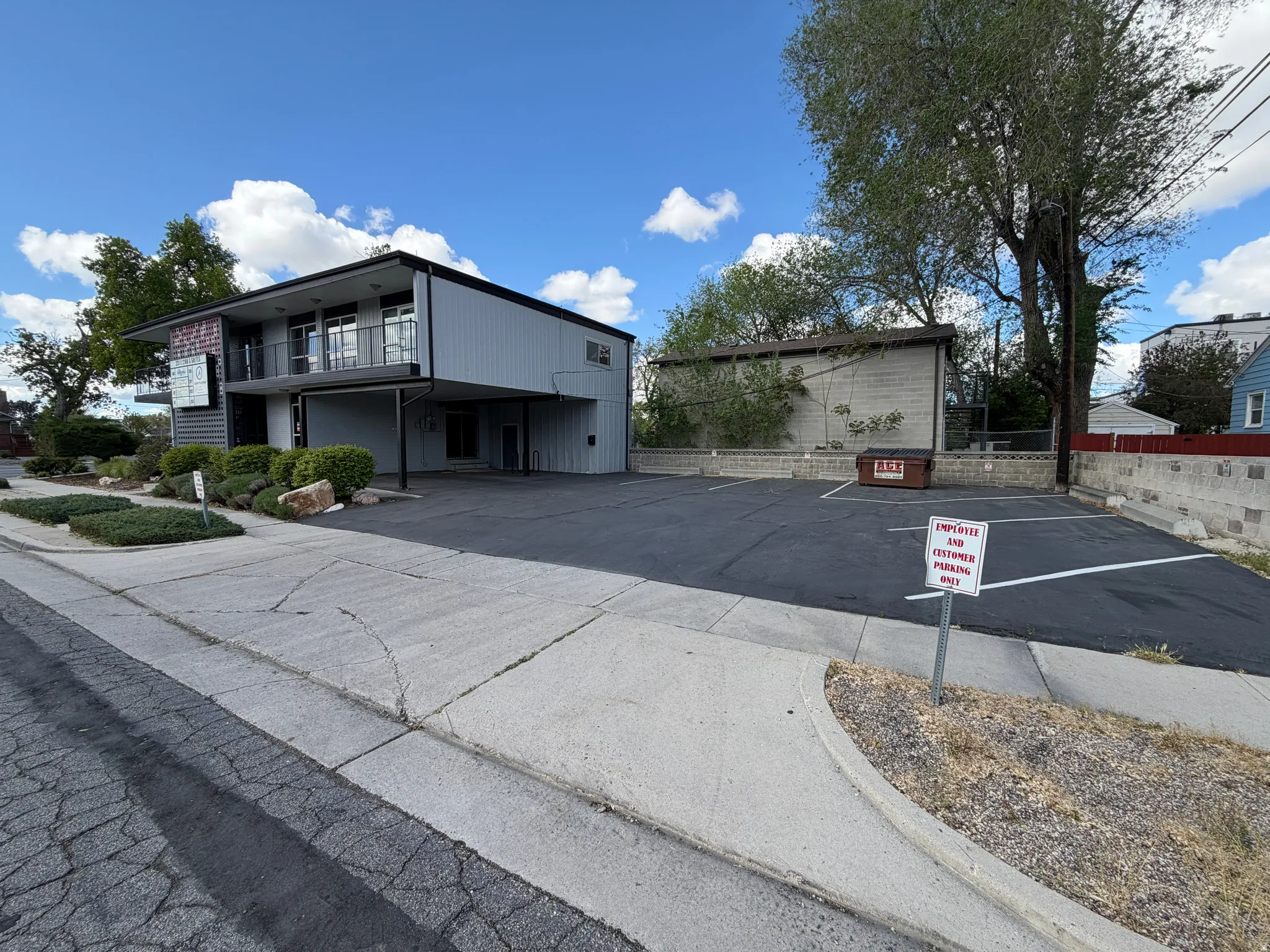 View of building exterior featuring uncovered parking