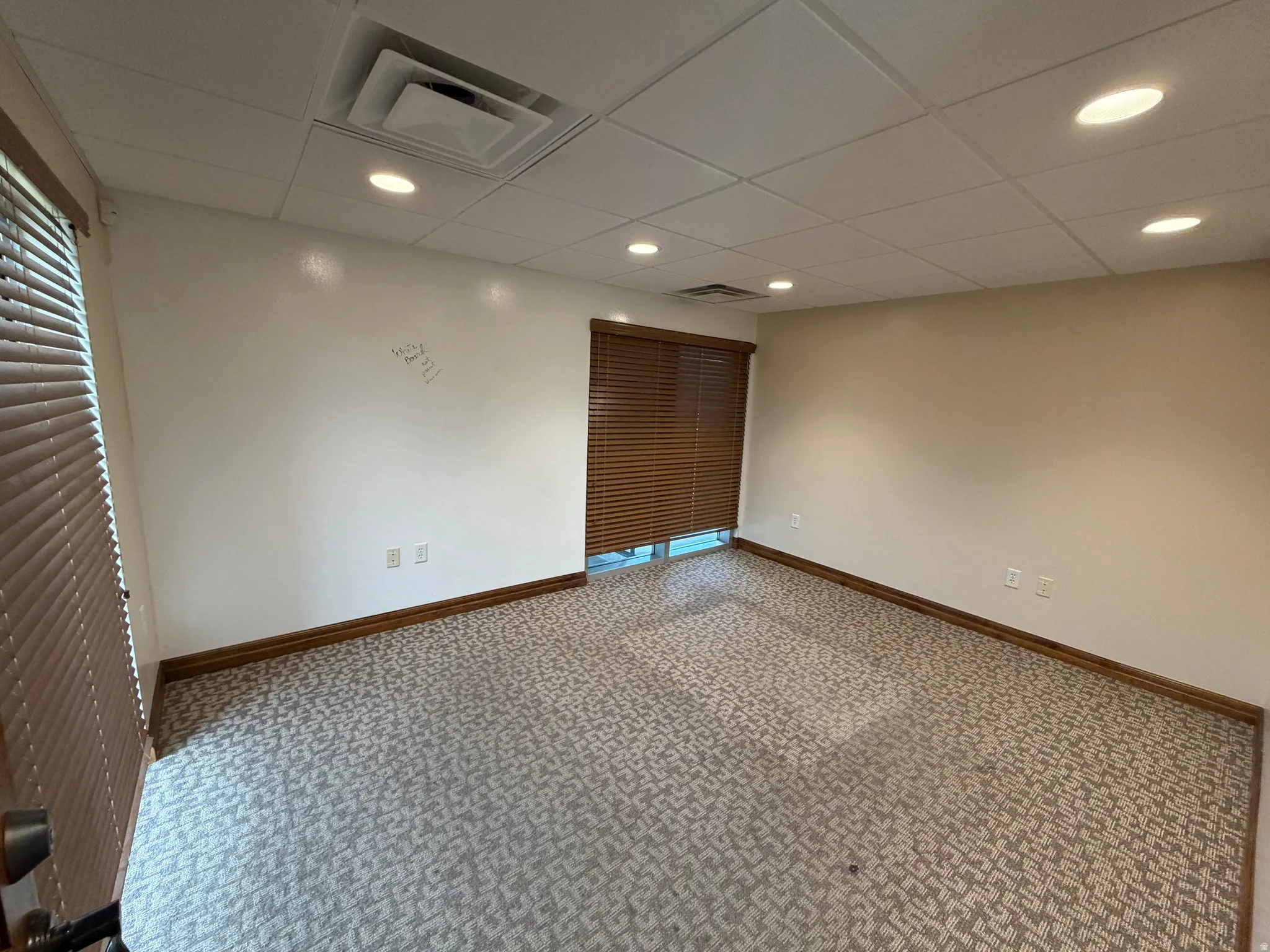 Unfurnished bedroom with carpet, recessed lighting, and a drop ceiling