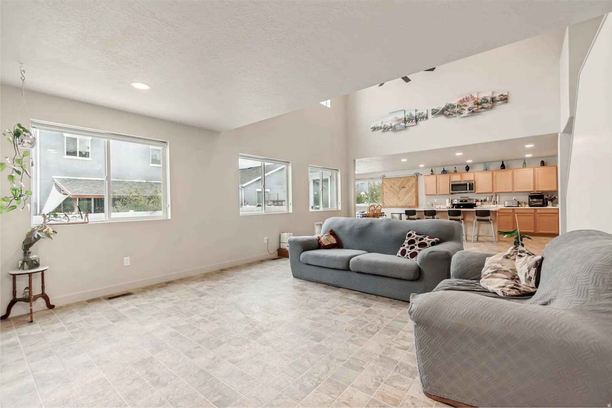 Living room with recessed lighting and a high textured ceiling