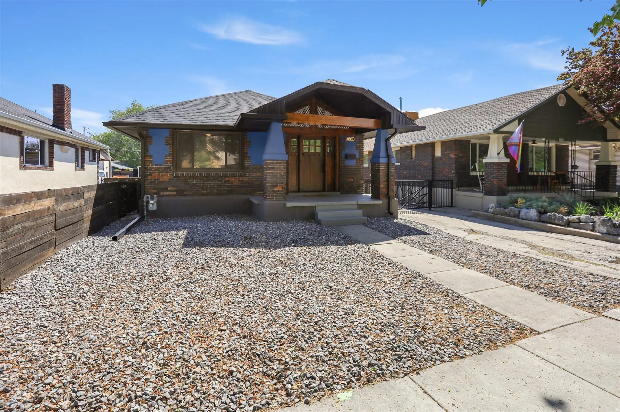 Bungalow-style house featuring brick siding and a shingled roof