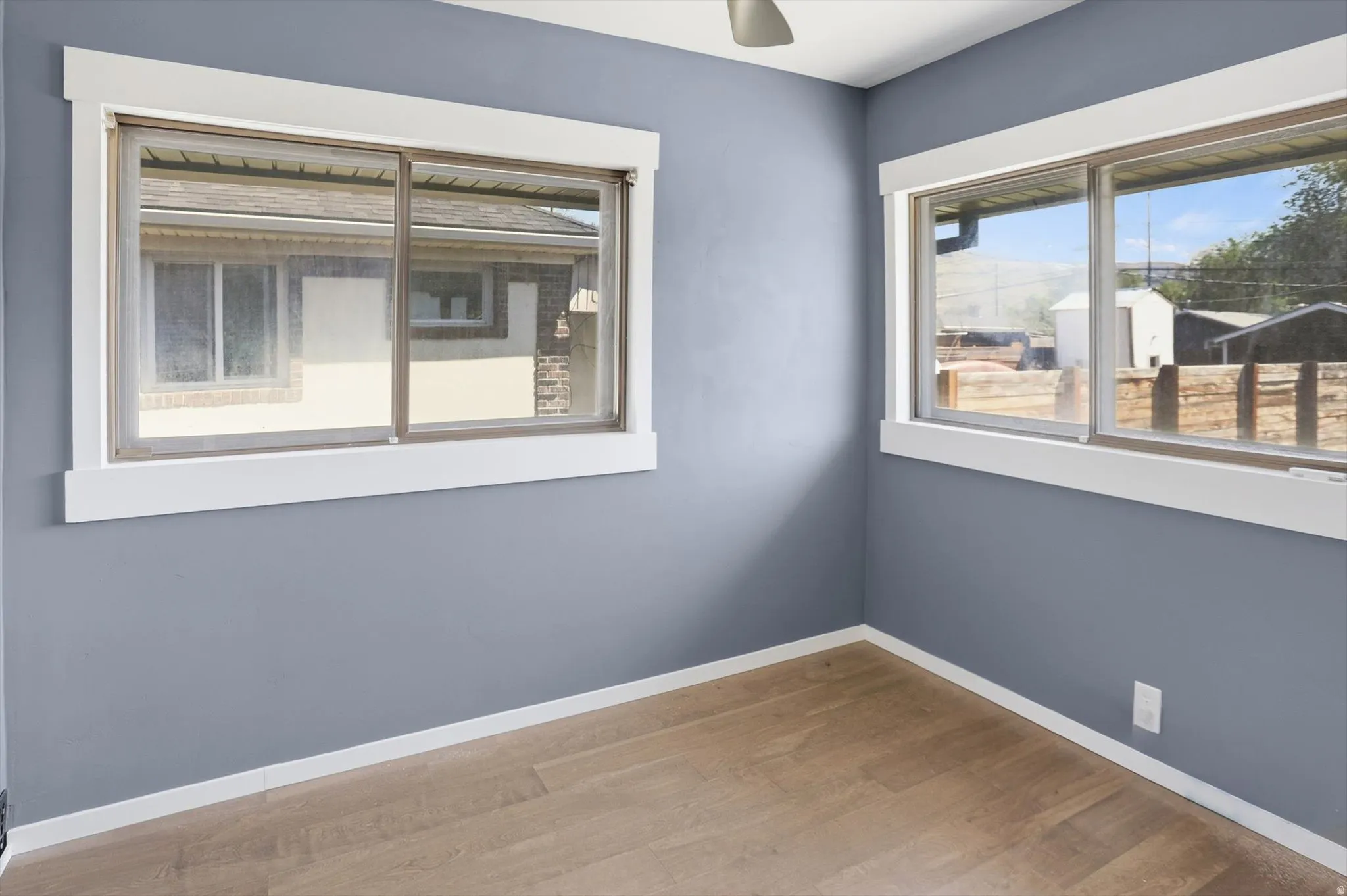 Unfurnished room featuring light wood-style flooring and a ceiling fan