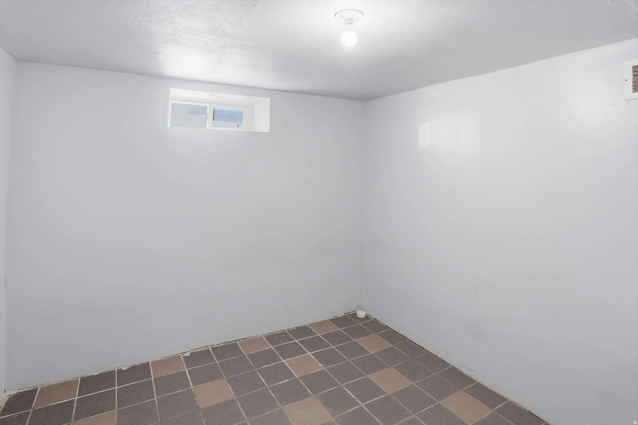 Below grade area with a textured ceiling